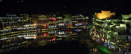 FENGHUANG, CHINA - SEPTEMBER 16, 2015: View of illuminated riverside houses in ancient town of Fenghuang known as Phoenix, Chinaのeditorial素材