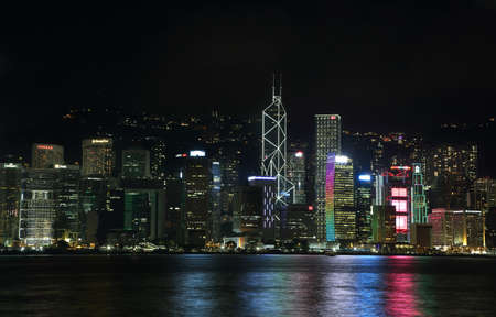HONG KONG, CHINA - SEPTEMBER 22, 2015: Skyline of the skyscrapers illuminated at night from Avenue of the Stars in Hong Kong.のeditorial素材