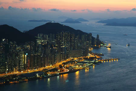 Skyline of the skyscrapers illuminated at sunset in Hong Kong islandのeditorial素材