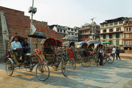 KATHMANDU, NEPAL - APRIL 9 2016: men in their rickshaws waiting for clients in the heart of the old town in Kathmandu, Nepalのeditorial素材