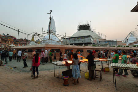 KATHMANDU, NEPAL - APRIL 20, 2016: tourist and devoted people walking around Boudhanath temple run down one year after the big Earthquake in Nepalのeditorial素材