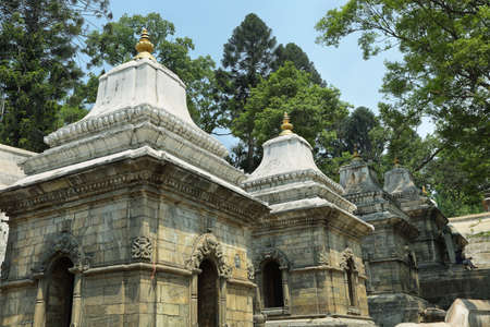 KATHMANDU, NEPAL - APRIL 20, 2016: Votive temples and shrines in a row at Pashupatinath Temple, Kathmandu, Nepal - Sri Pashupatinath Temple located on the banks of the Bagmati Riverのeditorial素材