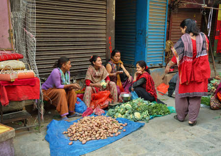 KATHMANDU, NEPAL - APRIL 20, 2016: women vendors selling vegetables seated in a street in the heart of the old town in Kathmandu, Nepalのeditorial素材