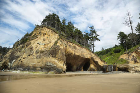 Small waterfall and cave in Hug point in Oregon, USAの写真素材