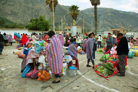 CARAZ, PERU - JUNE 7: women selling flowers in small stall in a morning flower market on June 7, 2017 in Caraz, Ancash province, Peruのeditorial素材