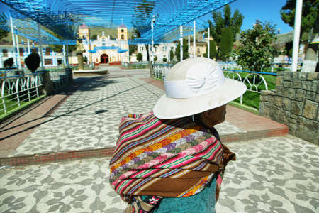San Pedro de Cajas, Peru - June 11, 2017: indigenous old woman walking in the main square of San Pedro de Cajas, village of artisans near Tarma, Peruのeditorial素材