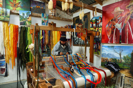 San Pedro de Cajas, Peru - June 11, 2017: colorful room with tapestries in the wall and a weaving loom in San Pedro de Cajas a village of artisans, Peru.のeditorial素材