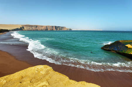 The coast and red sand beach of Paracas National Reserve in Peruの写真素材