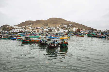 Pucusana, Peru - June 17, 2017: Peruvian fishermen boats in Pucusana pier in a cloudy morning in tourist town of Pucusana close to Lima, Peruのeditorial素材