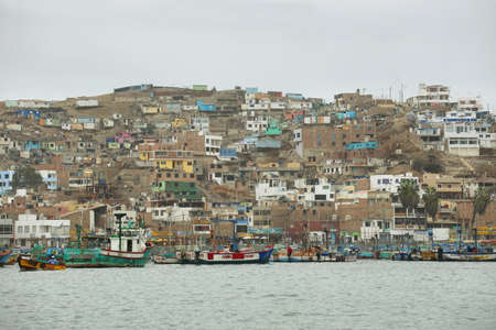 Pucusana, Peru - June 17, 2017: views of peruvian fishermen boats and houses in Pucusana village in a cloudy morning in tourist town of Pucusana close to Lima, Peruのeditorial素材
