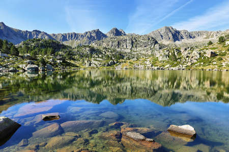 Reflection at the first lake in the circuit of Lake Pessons, Andorraの写真素材