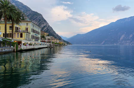 Limone sul Garda, Italy - July 2, 2019: Picturesque view of Limone sul Garda at sunset, Lake Garda, Italy. City of lemons and boatsのeditorial素材