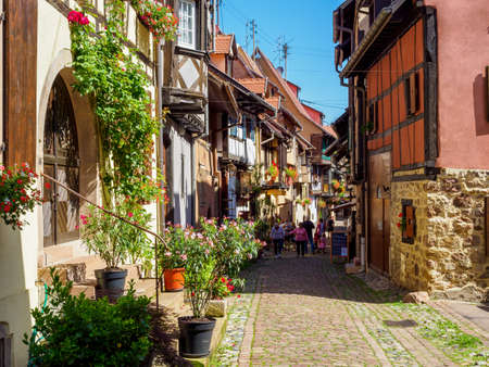 Eguisheim, France - July 18, 2021: Street with colorful traditional french houses in Eguisheim town of Alsace region, Franceのeditorial素材