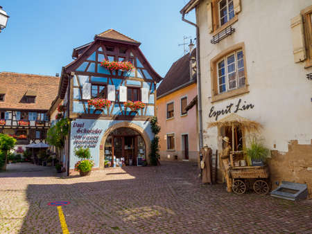 Eguisheim, France - July 18, 2021: Street with colorful traditional french houses in Eguisheim town of Alsace region, Franceのeditorial素材