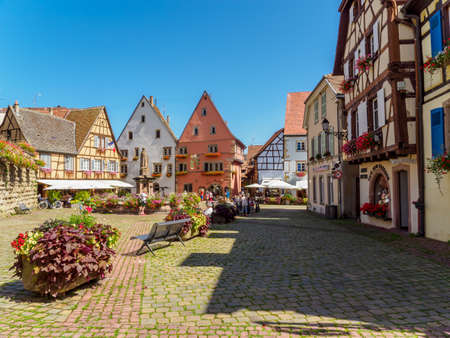 Eguisheim, France - July 18, 2021: Street with colorful traditional french houses in Eguisheim town of Alsace region, Franceのeditorial素材