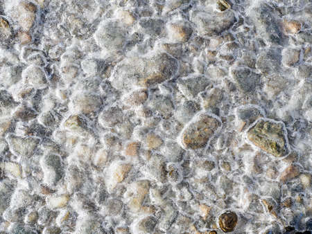 frosted stones in a chilly morning in french alps