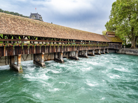 Thun, Switzerland - June 20, 2024: Old bridge in historic downtown in Thun, Kanton Bernese in Switzerlandの写真素材