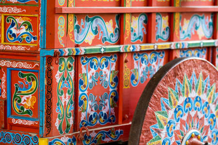 This is a beautiful blue and red wagon used to transport coffee beans on a historic plantation.