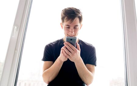 Handsome student at the  cell phone.