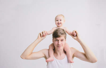 man playing with his baby on white backgroundの写真素材