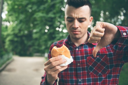 Man opening a hamburgerの写真素材