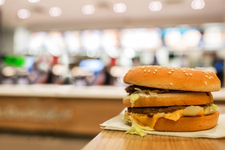 cheeseburger on the table. On the background of of fast food restaurants.の写真素材