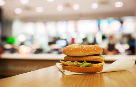 cheeseburger on the table. On the background of of fast food restaurants.の写真素材