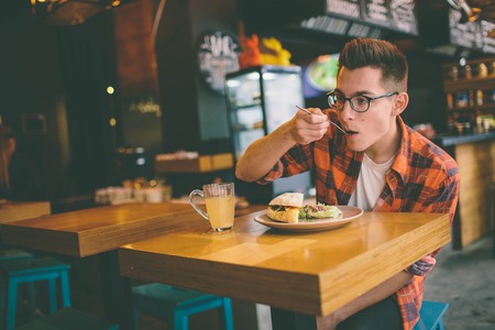 Man eating in a restaurant and enjoying delicious foodの写真素材