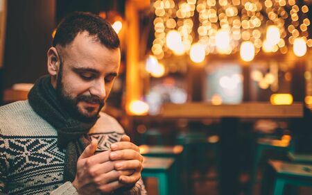 portrait of handsome guy is holding coffee cupの写真素材