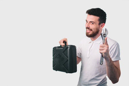 Funny portrait craftsmen use tools for repairの写真素材