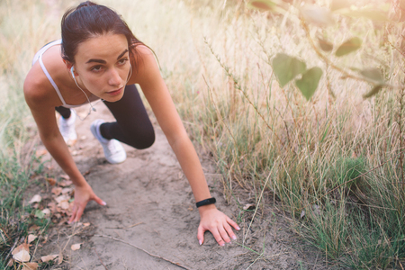 Beautiful woman running during sunset. Dressed in sportswear.の写真素材