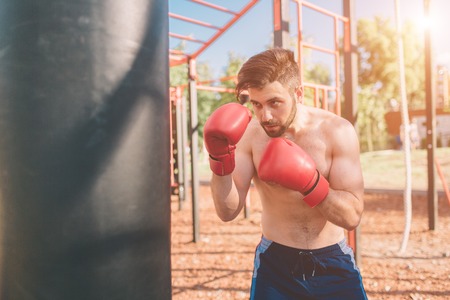 Young man boxing workout. Boxer Exercise Athletic Boxing Concept. boxer punch hand by punching bag.の写真素材