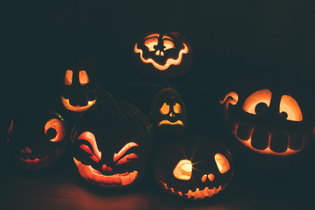 Ghost pumpkins on Halloween. ead Jack on Dark background. Holiday indoor decorations.の写真素材