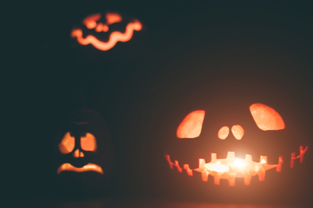 Ghost pumpkins on Halloween. head Jack on Dark background. Holiday indoor decorations.の写真素材