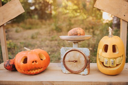 Ghost pumpkins on Halloween. ead Jack on an autumn background. Holiday outdoor decorationsの写真素材
