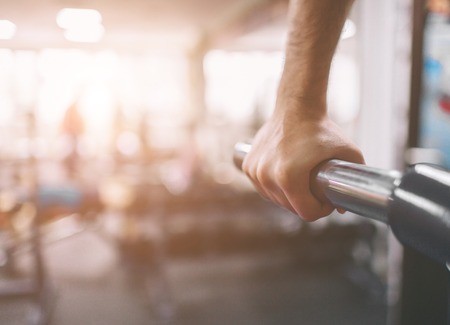 The hand is close-up. Workout in the gym. Dips on parallel bars . Indoor fitness.