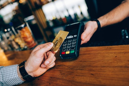 Close up of small device that uses for payments. You can use any type of card to pay for your order....