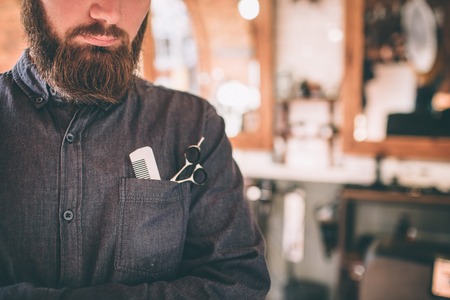 Cut view of a hair stylist. He has all tools in a chest pocket that he needs.の写真素材