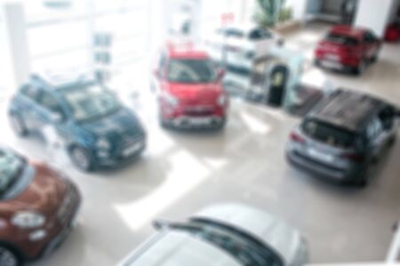 Kiev, Ukraine - September 11, 2018. Unclear picture of cars with different colours. They are in one room with glass walls. It is sunny and bright insideのeditorial素材