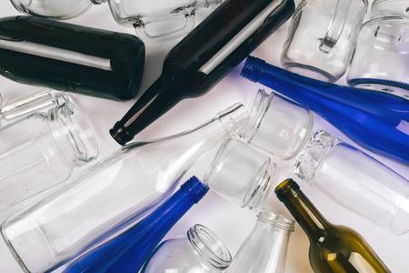 Reduce reuse recycle. Sorting waste. Empty colorful glass bottles are prepared for recycling on dark background. Protect the environment. Top viewの写真素材