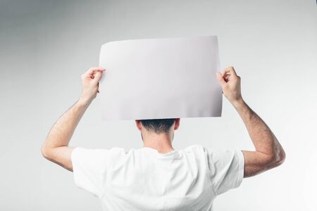 isolated on white background man holds a poster bearded.の写真素材