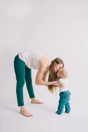 Portrait of happy mother with her little baby in her room.の写真素材