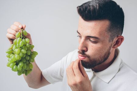 man holding grape, close up. concept. isolated on whiteの写真素材
