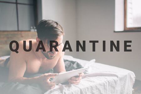Young man relaxation on the bed and using digital tablet