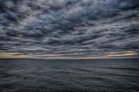 We watched from a cliff into the sea infinite feeling of uneasiness clouds
