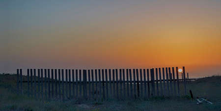 Between sunset tables to check the dunes of a beach.の写真素材