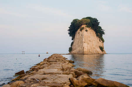Natural stone formation, on the Japanese coast, known as a battleship, due to its shape that remembers the front of a battleshipの写真素材