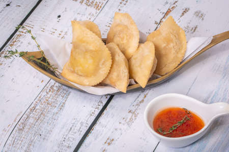 traditional Brazilian pastry where it is called pastel On white table with top view