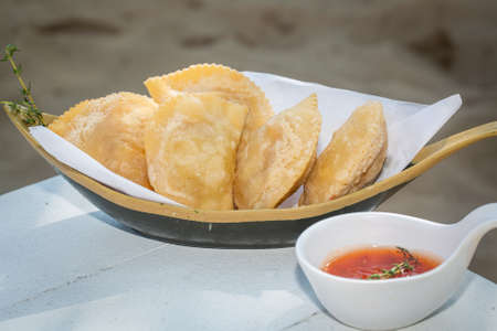 
traditional Brazilian pastry where it is called pastel. On white table with blurred background.の写真素材