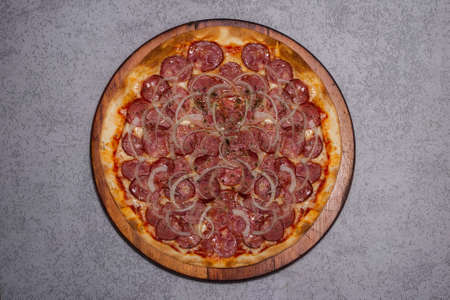 Pepperoni pizza on a wooden background. Grey background. View from the topの写真素材
